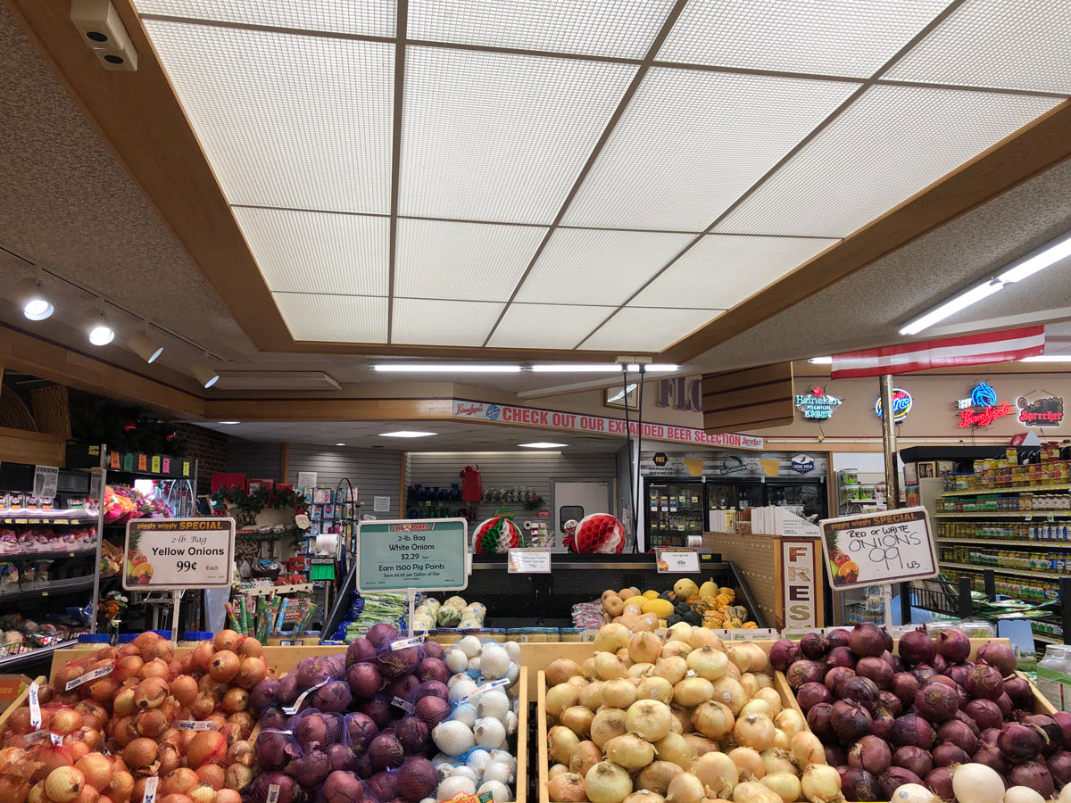 This AFTER photo shows a much brighter, more inviting produce department at a grocery store following installation of replacement LED tubes.